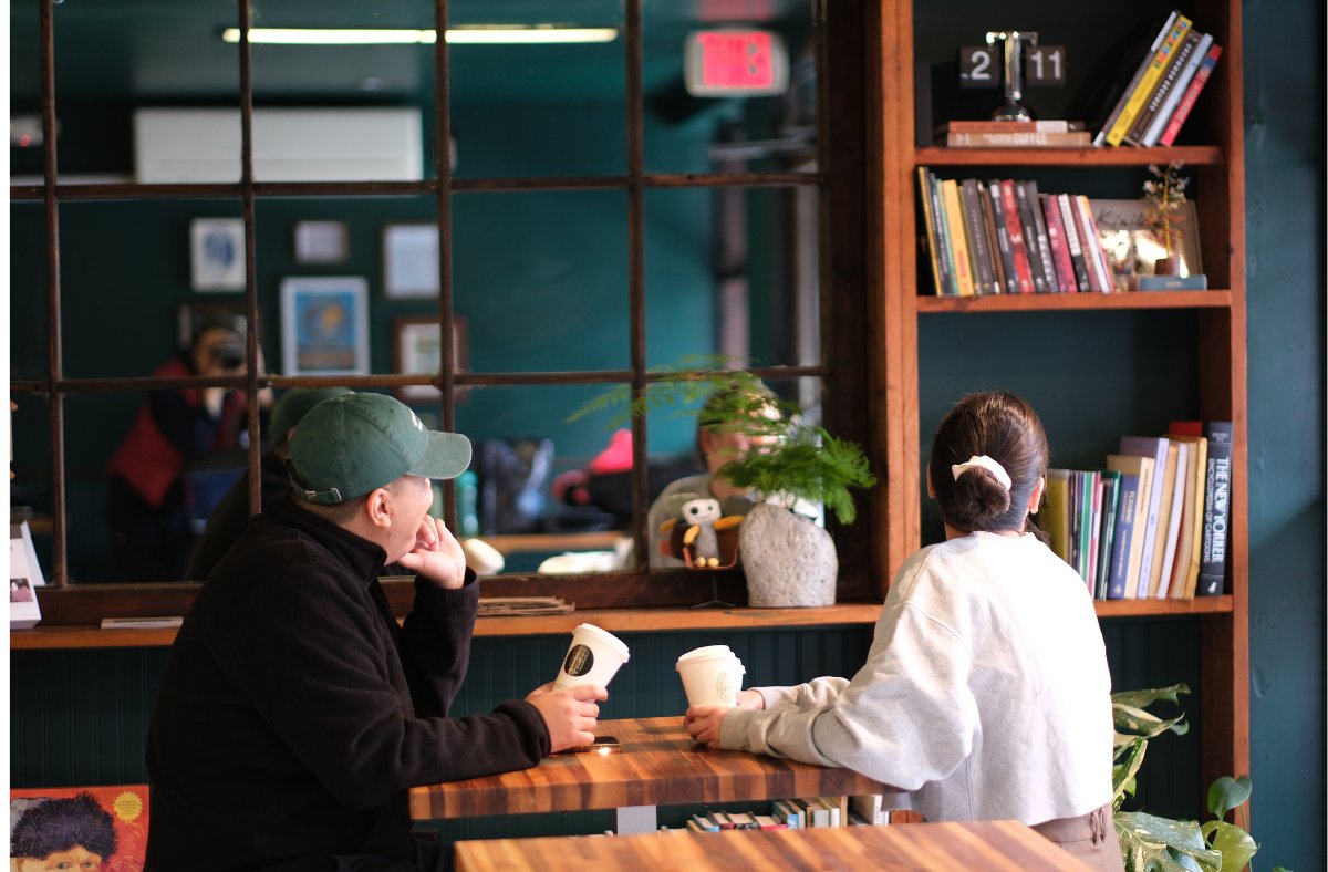 Guests chatting over coffee at the window bar